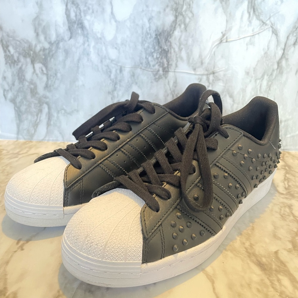 Black studded Adidas low tops